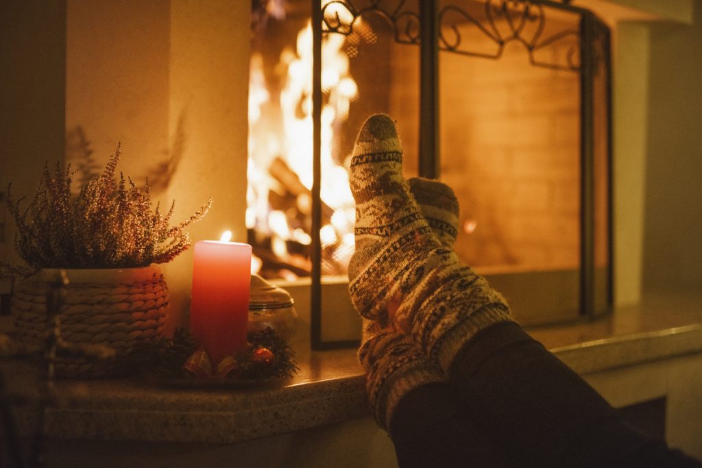 cozy stockinged feet by fireplace