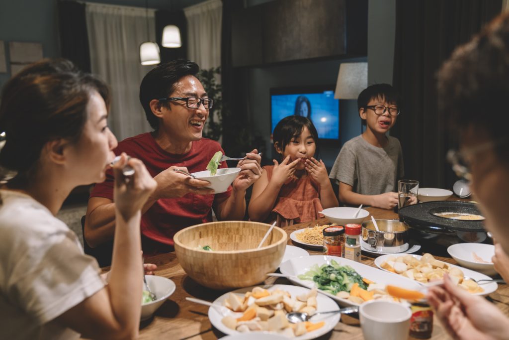 Asian family sharing a holiday meal of healthy food