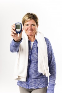 Diabetic woman holds up a glaucometer