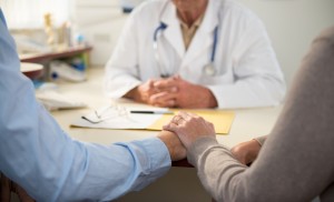 Worried mature couple with doctor